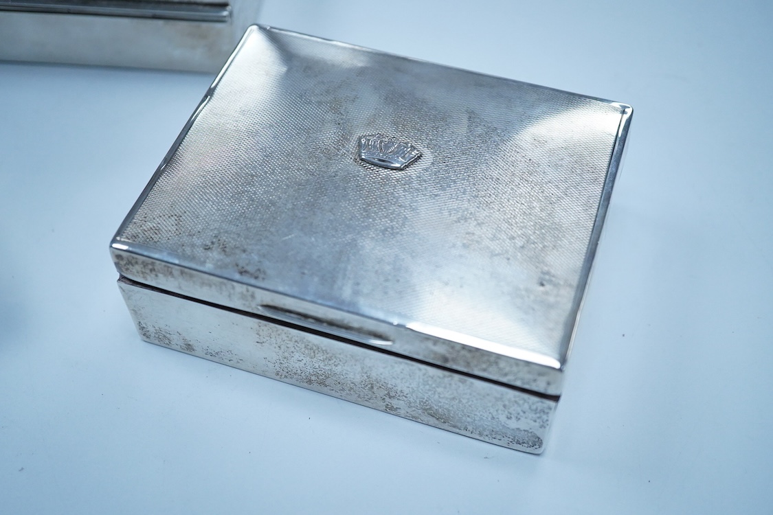 Three assorted George V/George VI silver mounted cigarette boxes, including two with engine tuned covers, the largest by Joseph Gloster Ltd, Birmingham, 1946, 12.8cm.